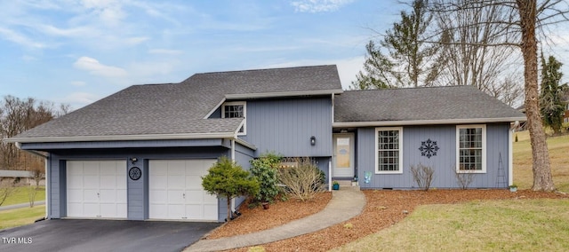 split level home with a garage, crawl space, and roof with shingles