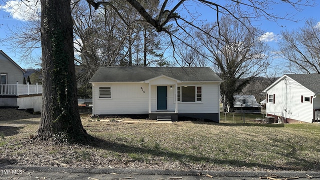 bungalow-style home featuring a front yard and fence