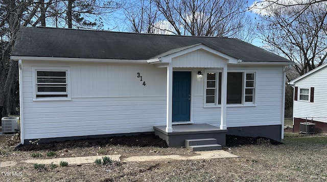 view of front of house featuring roof with shingles and central AC unit