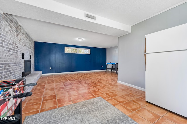 interior space with visible vents, baseboards, a textured ceiling, and tile patterned flooring