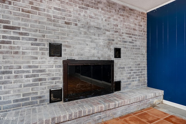 room details with visible vents, a fireplace, a textured ceiling, and crown molding