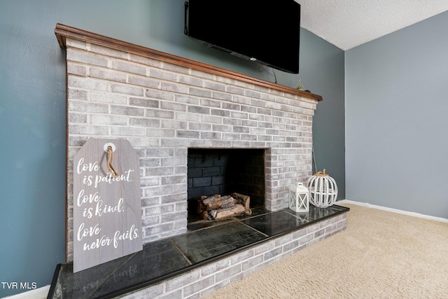 room details with baseboards, carpet floors, a textured ceiling, and a fireplace