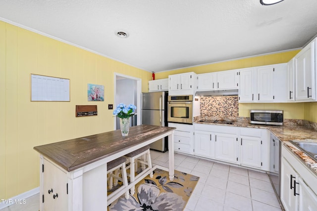 kitchen featuring white cabinetry, extractor fan, light tile patterned floors, and stainless steel appliances