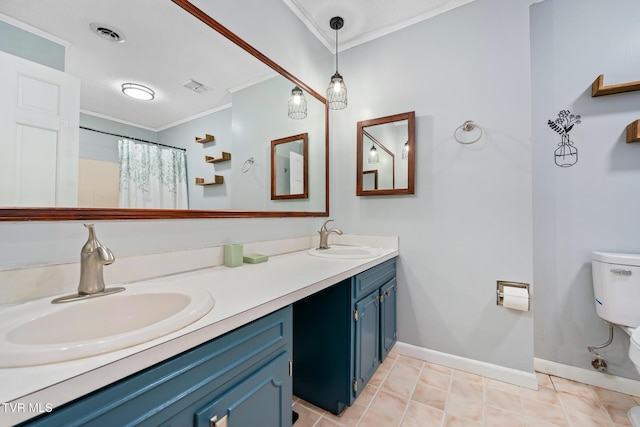 bathroom featuring toilet, ornamental molding, visible vents, and a sink