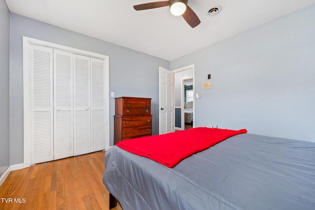 bedroom featuring a closet, visible vents, a ceiling fan, and wood finished floors