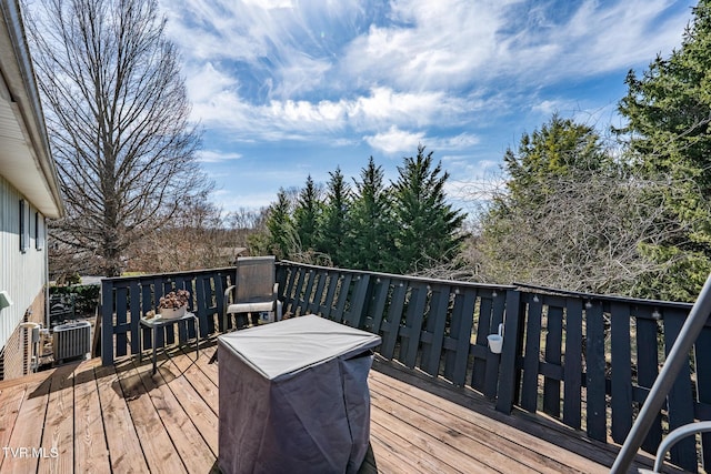 wooden deck featuring cooling unit