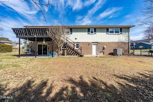 back of house with a patio, stairway, central AC unit, a lawn, and brick siding