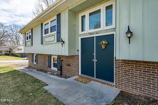 view of exterior entry with brick siding