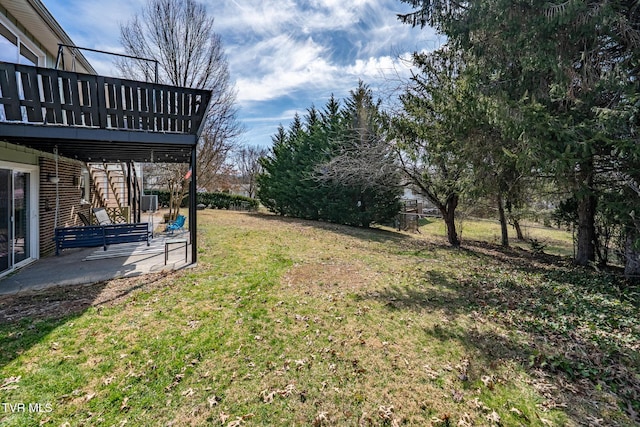 view of yard with a patio area and a wooden deck