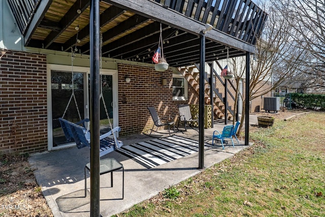 view of patio featuring stairway and central AC unit