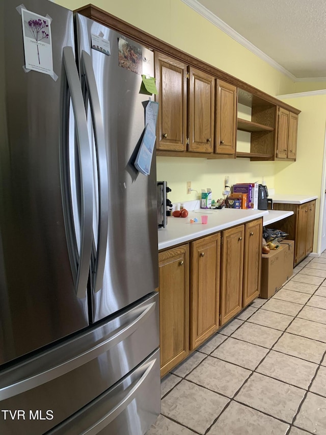 kitchen with open shelves, a textured ceiling, freestanding refrigerator, crown molding, and light countertops