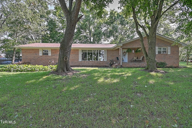 single story home with brick siding and a front yard