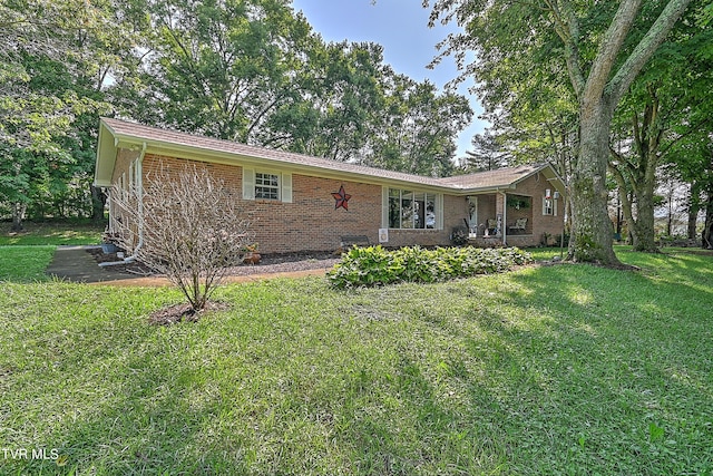 single story home featuring a front lawn and brick siding