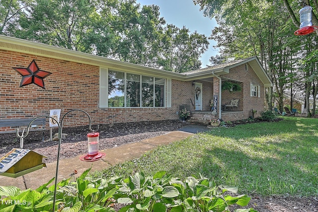 ranch-style house with brick siding and a front yard