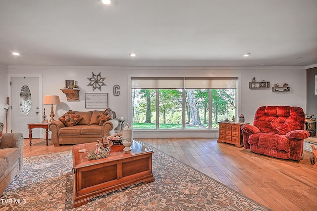 living room featuring recessed lighting, wood finished floors, and ornamental molding