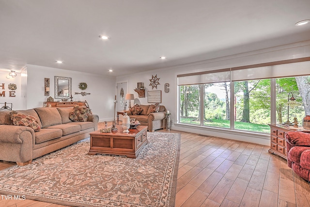 living area with recessed lighting, ornamental molding, and wood finished floors