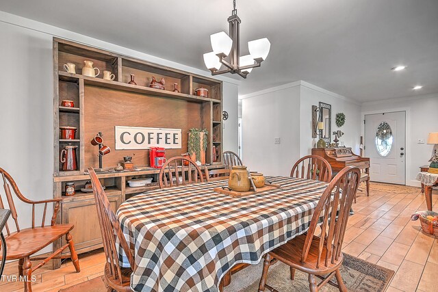 dining space featuring a notable chandelier, recessed lighting, and light wood-type flooring