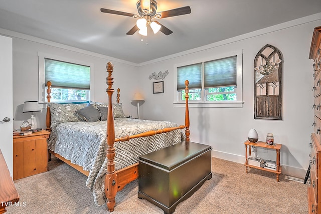 carpeted bedroom featuring crown molding, baseboards, and ceiling fan