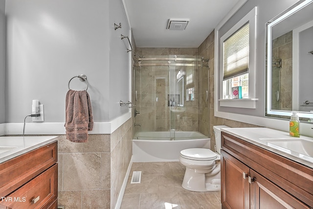 bathroom featuring visible vents, toilet, tile walls, and vanity