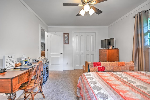 carpeted bedroom featuring a closet, ornamental molding, and a ceiling fan