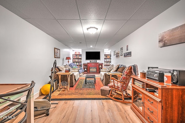 living room featuring a drop ceiling and wood finished floors