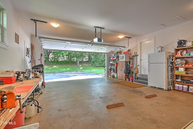 garage with a garage door opener and freestanding refrigerator