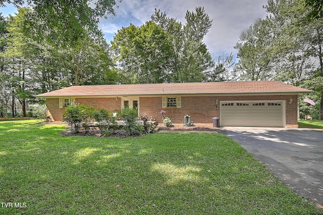 ranch-style house with aphalt driveway, a front yard, a garage, and brick siding