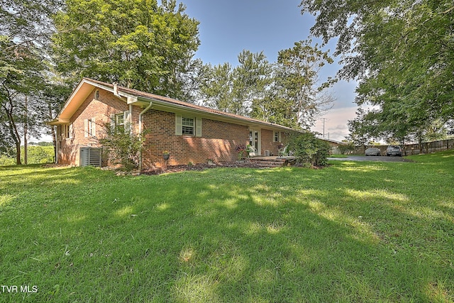 ranch-style home featuring brick siding and a front lawn