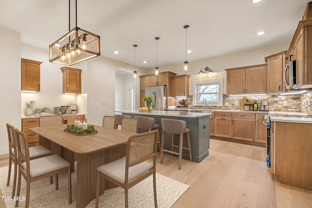 dining area featuring recessed lighting and light wood-style flooring