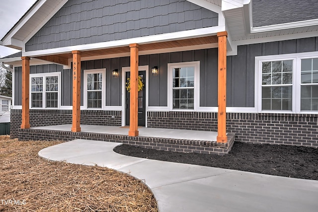 entrance to property with a porch and board and batten siding