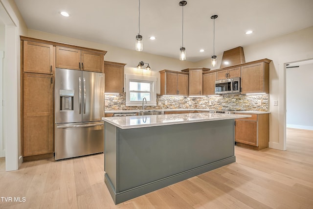 kitchen with a center island, light wood-type flooring, backsplash, and stainless steel appliances