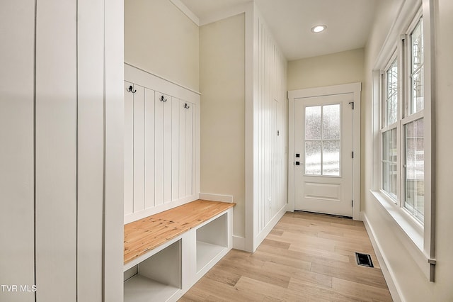 mudroom featuring visible vents, baseboards, and light wood-style flooring