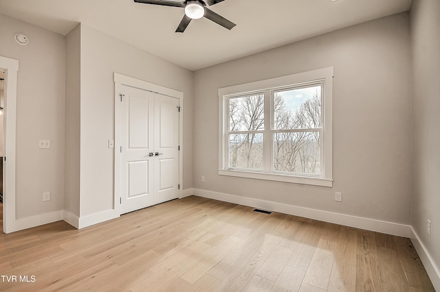 unfurnished bedroom featuring visible vents, baseboards, and light wood-style floors