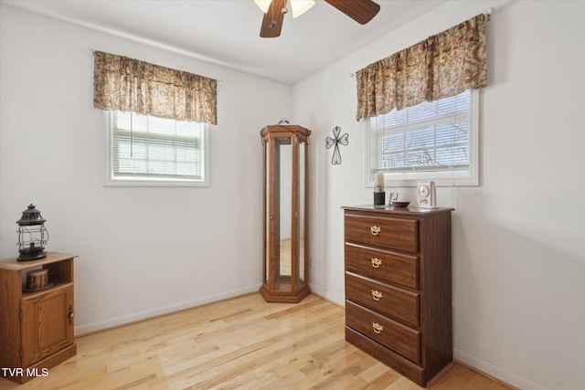 bedroom featuring light wood-style flooring, multiple windows, and baseboards