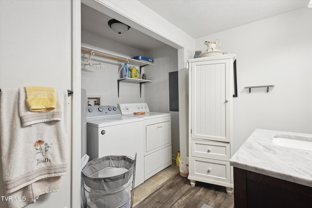 laundry area with a sink, independent washer and dryer, dark wood-style floors, and laundry area