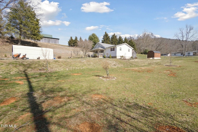 view of yard with a storage unit and an outbuilding