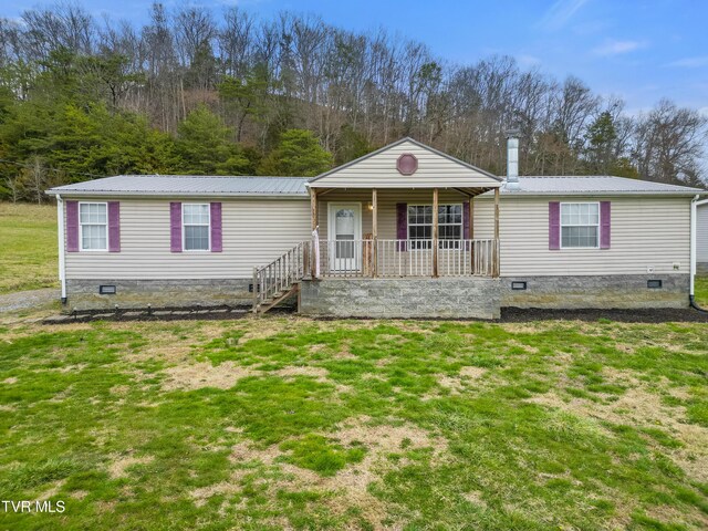 manufactured / mobile home with crawl space, a porch, metal roof, and a front yard