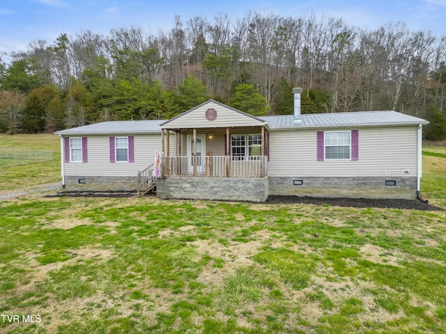 view of front of home featuring a porch, a front yard, crawl space, and metal roof