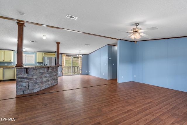 unfurnished living room featuring a textured ceiling, visible vents, wood finished floors, and ceiling fan with notable chandelier