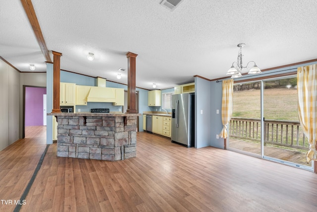 kitchen featuring visible vents, custom range hood, cream cabinets, appliances with stainless steel finishes, and wood finished floors