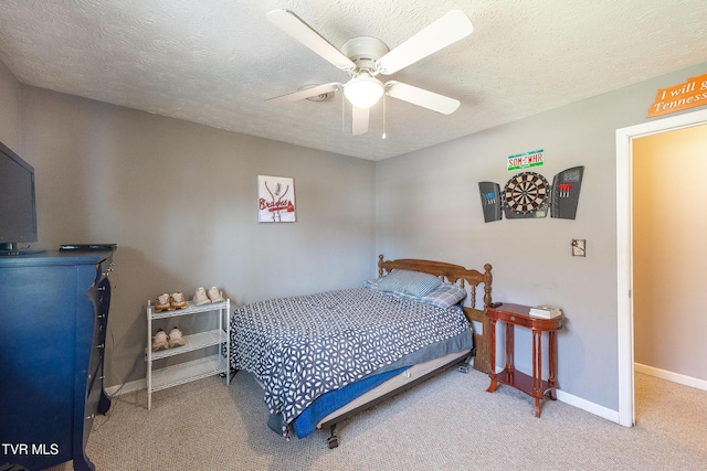 carpeted bedroom with ceiling fan, a textured ceiling, and baseboards