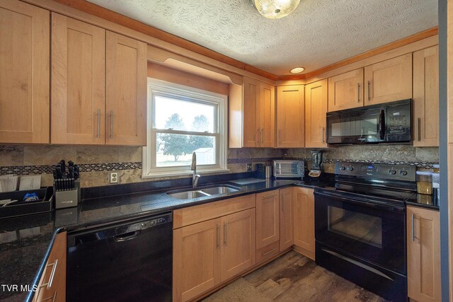 kitchen with dark wood-style floors, a sink, a textured ceiling, black appliances, and backsplash