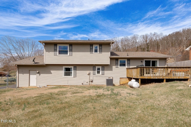 back of property featuring a yard, central AC, fence, and a wooden deck