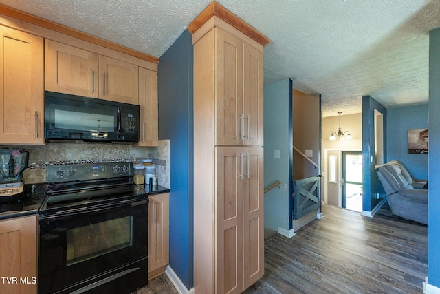 kitchen with dark wood-type flooring, dark countertops, backsplash, and black appliances