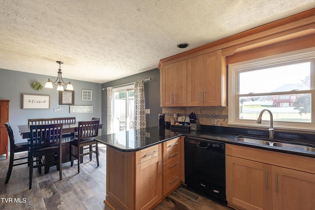 kitchen with black dishwasher, dark wood-style floors, a peninsula, a chandelier, and a sink