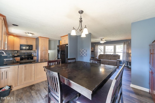 dining space featuring ceiling fan, a textured ceiling, baseboards, and dark wood-type flooring