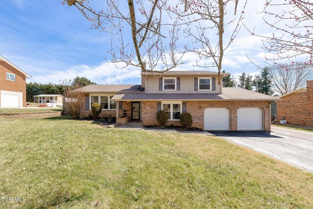 tri-level home featuring driveway, brick siding, an attached garage, and a front yard