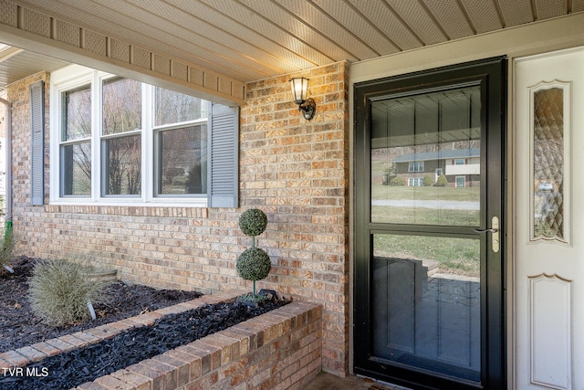 property entrance with brick siding