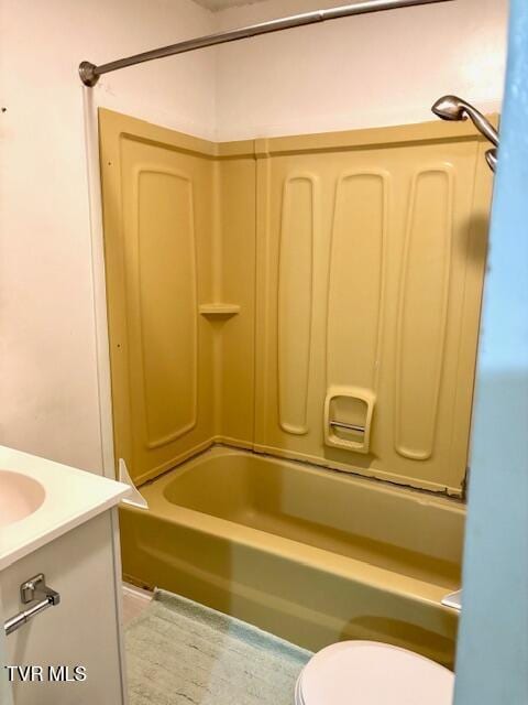 full bathroom featuring tub / shower combination, vanity, and toilet