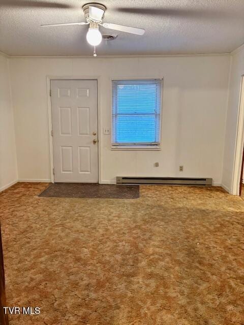 carpeted foyer entrance featuring crown molding, a textured ceiling, a baseboard heating unit, and a ceiling fan